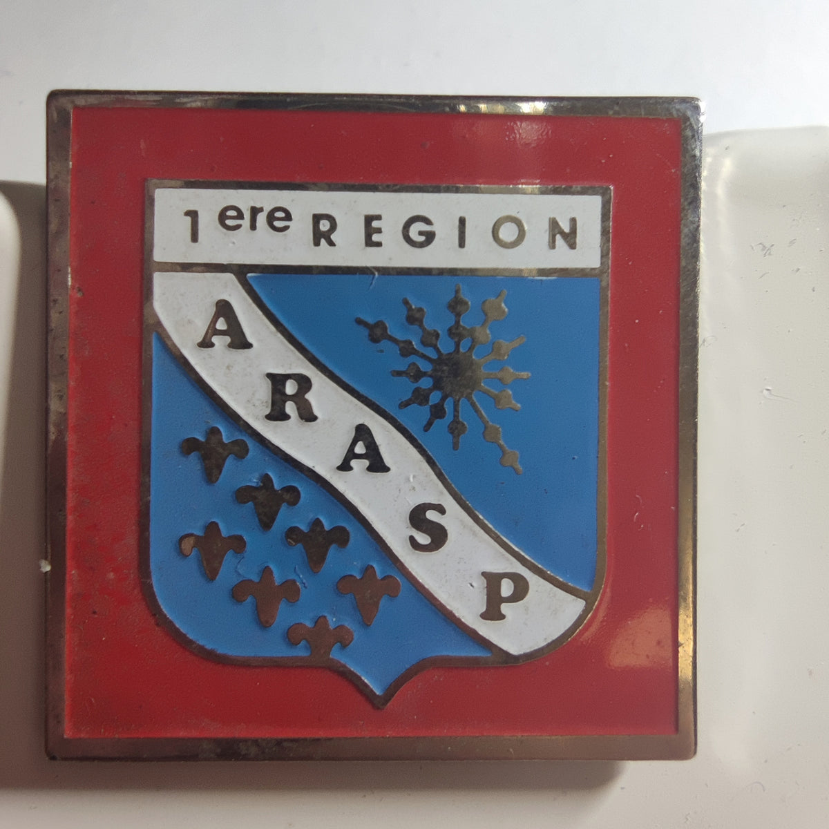 Pin’s ARASP, 1re région, modèle carré, vers 1990